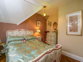 A bedroom with a bed and nightstand at White House