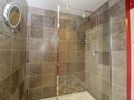 A shower with tiled walls and a mirror at White House