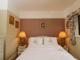 A bedroom with a bed and lamps at White House in 