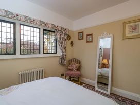 A bedroom with a mirror and a chair at White House