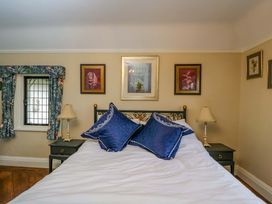 A bedroom with a bed and two framed artworks at White House