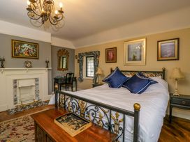 A bedroom with a bed and artwork on the walls at White House
