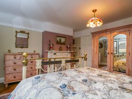 A bedroom with a bed and dresser at White House 