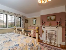 A bedroom with a bed and a chest of drawers at White House