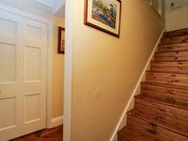 A hallway with stairs and a door at White House 