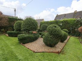 A garden area with shaped bushes and gravel path at White House