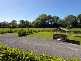 A gazebo with seating area and green space at Yes Deer in Ashbourne