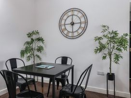 A dining room with a black table and chairs at Gannet in Flamborough