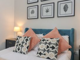 A bedroom with a bed and framed art at Gannet in Flamborough