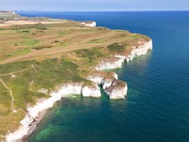 An aerial view of cliffs and ocean at Gannet in Flamborough