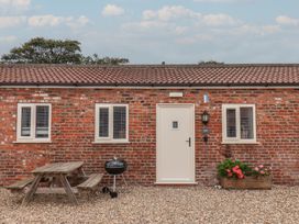 An outdoor view of a brick building with a door and windows at Gannet Flamborough