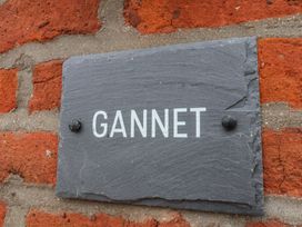 A slate sign GANNET mounted on a brick wall at Gannet Flamborough