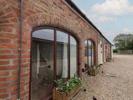 An exterior view of a brick building with windows and flower boxes at Razorbill in Flamborough