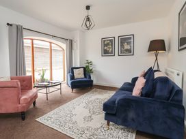 A living room with a sofa, armchair, and coffee table at Razorbill, Flamborough