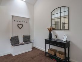 An entryway with a bench and coat hooks at Razorbill in Flamborough