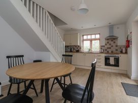 A kitchen with a table and chairs at Razorbill in Flamborough