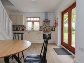 A kitchen with a table and chairs at Razorbill in Flamborough