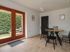 A dining room with a table and chairs at Razorbill in Flamborough