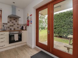 A kitchen with a glass door leading to a garden at Razorbill in Flamborough