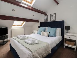 A bedroom with a bed and television at Razorbill in Flamborough