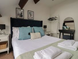A bedroom with a bed and bedside table at Razorbill in Flamborough