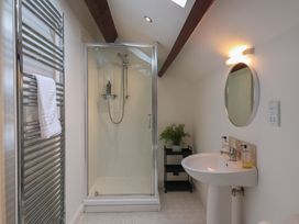 A bathroom with a shower and sink at Razorbill in Flamborough
