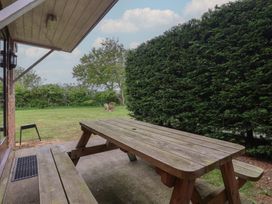 An outdoor seating area with a wooden table and benches at Razorbill in Flamborough