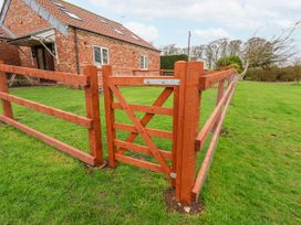 A fence and gate in front of a house at Razorbill in Flamborough