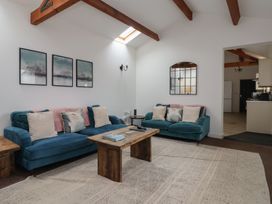A living room with sofas and a wooden table at Puffin in Flamborough