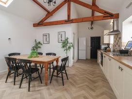 A kitchen with a dining table and chairs at Puffin in Flamborough
