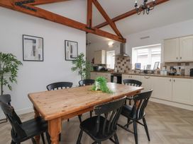A dining room with a wooden table and chairs at Puffin in Flamborough