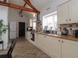 A kitchen with cabinets and appliances at Puffin in Flamborough