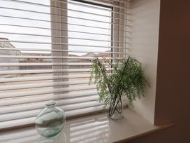 A window with plant and glass vase at Puffin in Flamborough