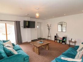 A living room with a coffee table and television at Kittiwake in Flamborough