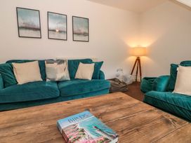 A living room with a sofa and coffee table at Kittiwake in Flamborough