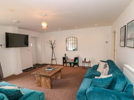 A living room with a coffee table and a television at Kittiwake Flamborough