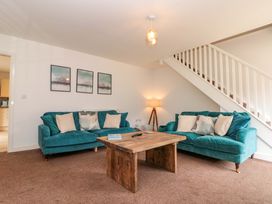 A living room with sofas and a coffee table at Kittiwake in Flamborough