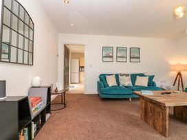 A living room with a sofa and coffee table at Kittiwake in Flamborough