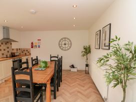 A kitchen with a dining table and chairs at Kittiwake in Flamborough
