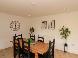 A dining room with a wooden table and chairs at Kittiwake in Flamborough