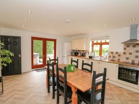 A kitchen with a dining table and chairs at Kittiwake Flamborough