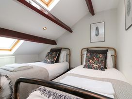 A bedroom with two beds and a skylight at Kittiwake in Flamborough