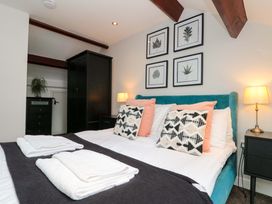 A bedroom with a bed and dresser at Kittiwake in Flamborough