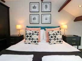 A bedroom with a bed and bedside tables at Kittiwake in Flamborough