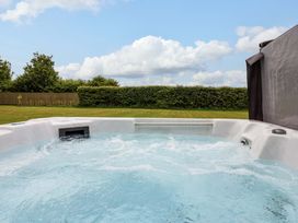 A hot tub with water in a garden at Kittiwake Flamborough