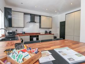 A kitchen with cabinets and a dining table at The Pheasantry in Flamborough