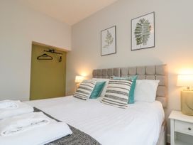 A bedroom with a bed and wall art at The Pheasantry in Flamborough