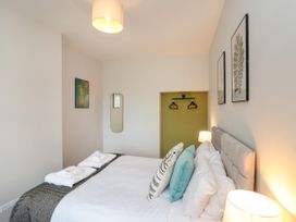 A bedroom with a double bed and mirror at The Pheasantry in Flamborough