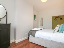 A bedroom with a bed and mirror at The Pheasantry in Flamborough