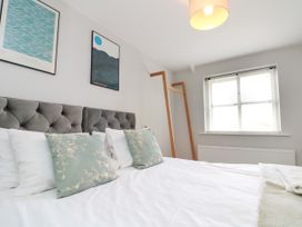 A bedroom with a bed and decorations on the wall at The Pheasantry in Flamborough
